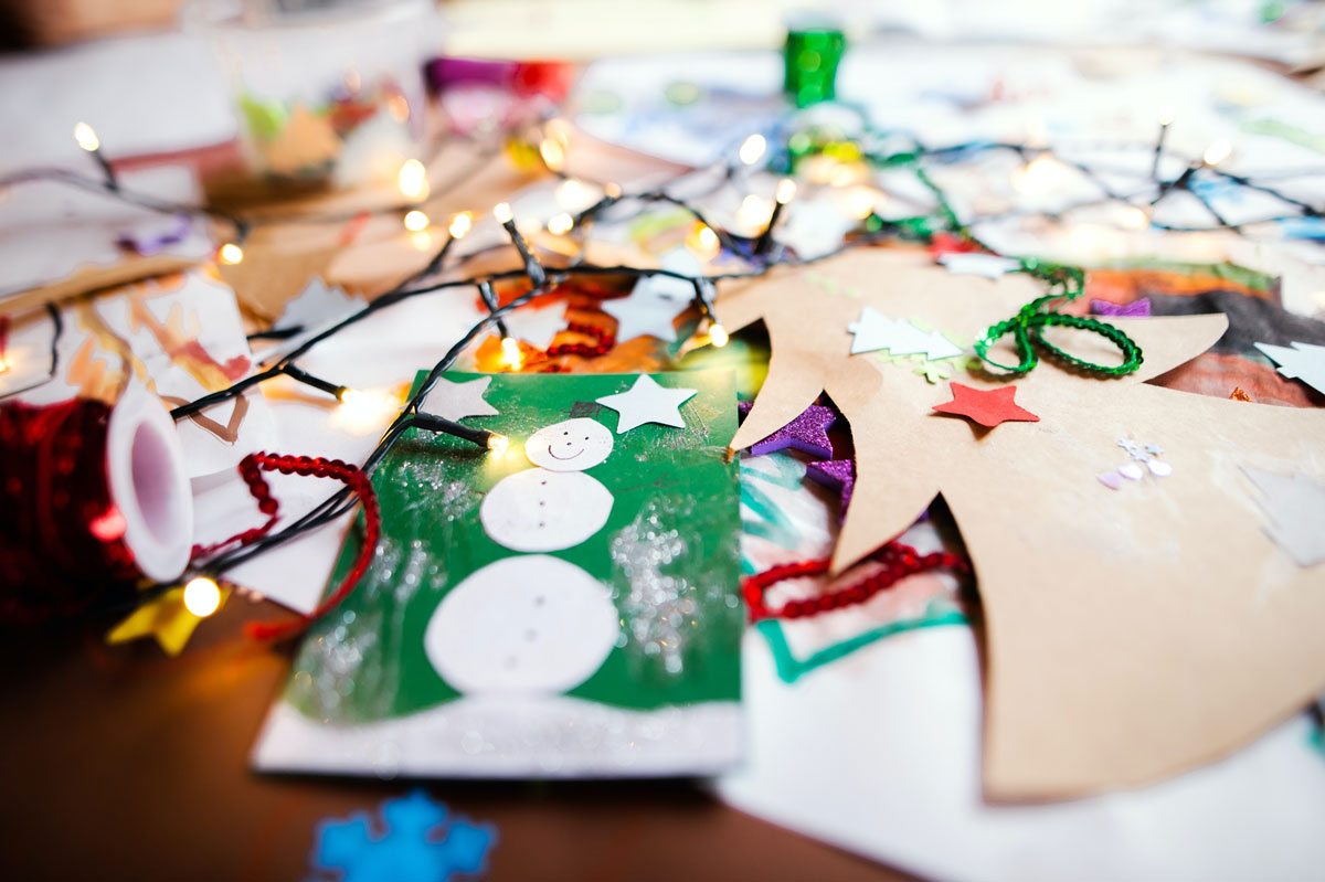 handmade holiday decorations scattered on table